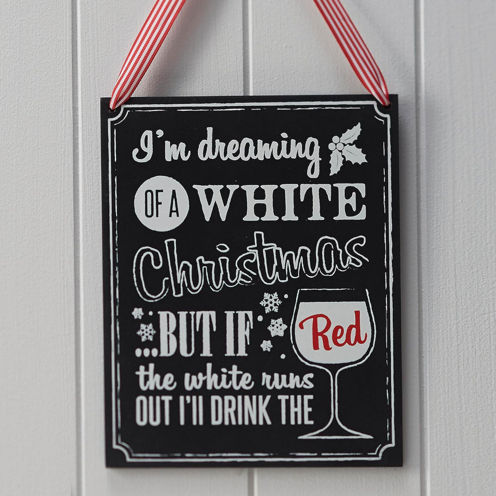 Decorative sign with text 'I'm dreaming of a white Christmas, but if the white runs out I'll drink the red' on a black background.